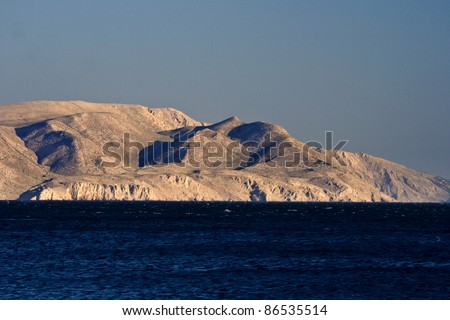View on the barren land island in front of Sveti Juraj and the deep blue sea