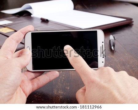 Old fashioned leather folder with blank paper and a modern smartphone