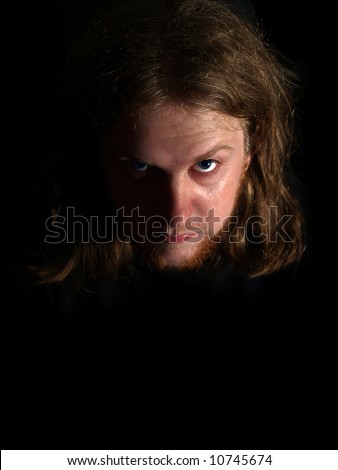 A scary man with bright blue eyes staring at you