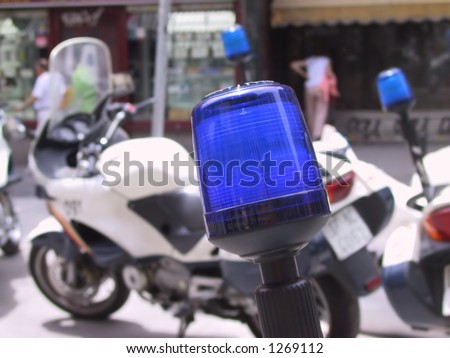 close up of a police light with a police motorcycle in the background