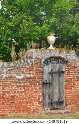 Garden gate with red brick wall