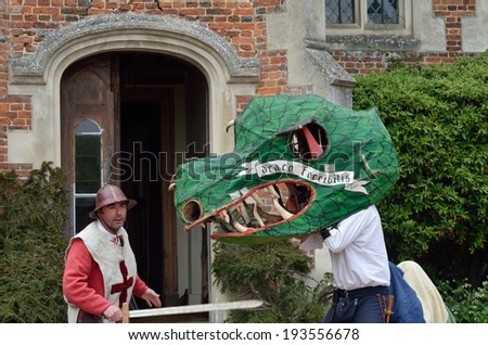 KENTWELL HALL SUFFOLK UK Ã¢Â?Â? May 05, 2014: Man dressed as Dragon and St George actor  in George and the dragon play reenactment