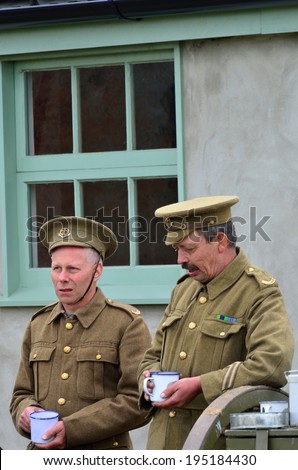 STOWE MARIES  AIRFIELD ESSEX UK FLYING DAY: May 14 2014,  Two men in World war one uniform having a cup of tea chatting