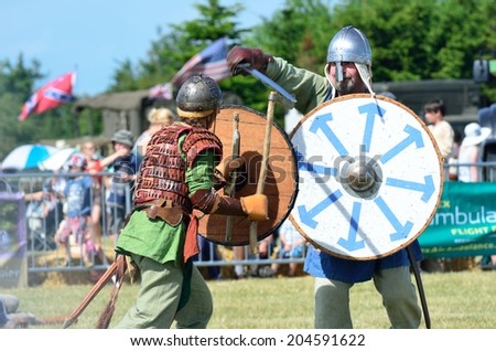 Blackwater Country Fare MALDON ESSEX UK 22 June 2014:  Two Vikings fighting with sword and shields