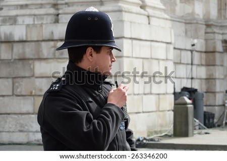 CITY OF LONDON ENGLAND 13 March 2015:  English Policeman with radio