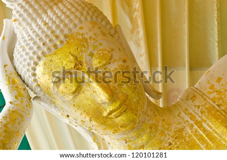 Sleeping white Buddha statue with gold leaf  in Thailand