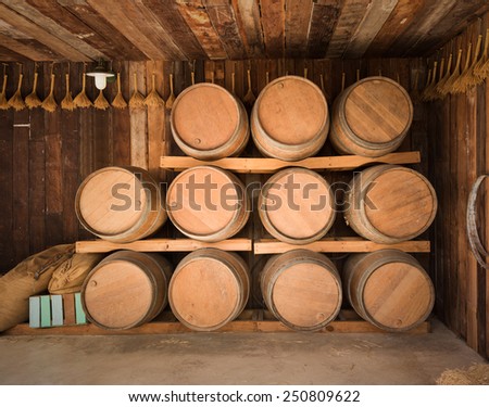 close up wine barrels stacked in old wine cave
