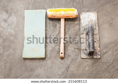 close up construction tools for concrete job on background of polished concrete surface