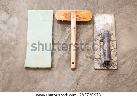 close up construction tools for concrete job on background of polished concrete surface