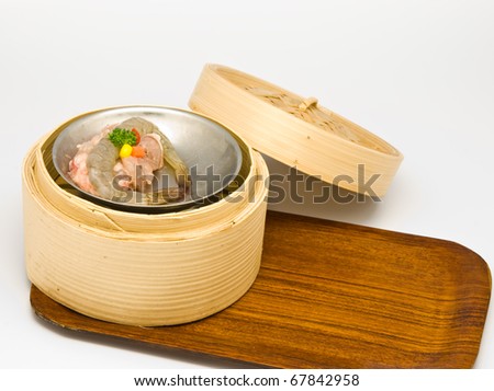 Chinese steamed shrimp dimsum in bamboo containers traditional cuisine in gray background