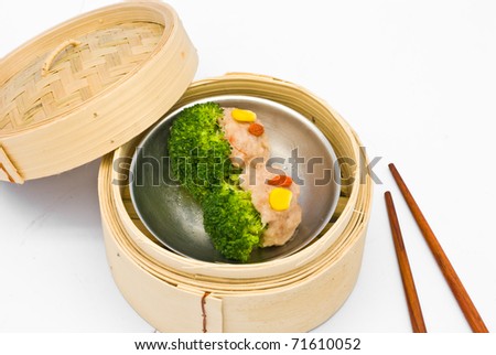 Chinese steamed dimsum broccoli in bamboo containers traditional cuisine
