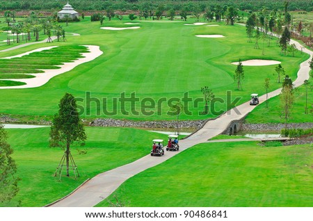 landscape picture of a golf court with golf cart