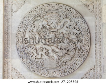 Chinese dragons engraving embossed in stone on the Buddha Temple walls, Gansu province, China.