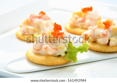 Closeup Of Caviar And Cream Cheese Appetizer On Crackers