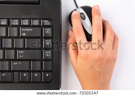 Close-up of female hand on mouse while working on laptop