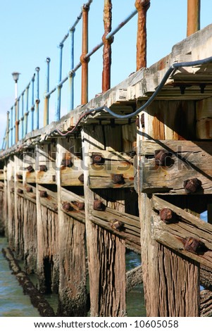 Old rusted ocean Pier at almost low tide