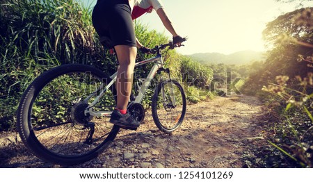 Woman cyclist riding a bike on a nature trail in the mountains.people living a healthy lifestyle