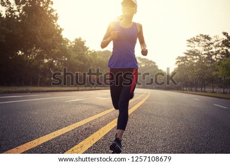 Runner athlete running on road. woman fitness  jogging  workout wellness concept