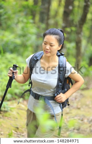 young asian woman hiker walking in jungle