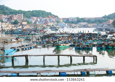 HUIDONG,GUANGDONG/ CHINA - SEPTEMBER 08: Fishing village/boats at shuangyuewan harbor in China,fishing is the major income source of people living there, on September 08,2013 in Huidong city, China