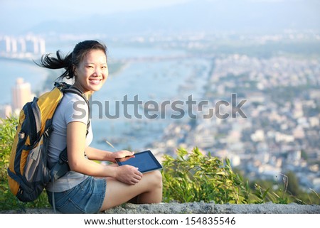 young asian woman hiker use digital tablet seaside mountain peak