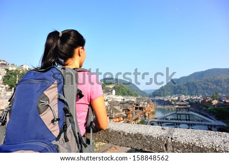 young asian woman tourist at fenghuang ancient town,china