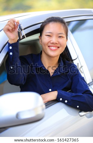 happy woman driver with her first car