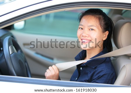 woman driver buckle up the seat belt before driving car