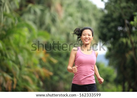 asian sports woman running at park