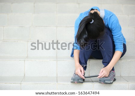 upset woman student use smart phone sit on stairs