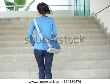 adult student running at stairs in campus