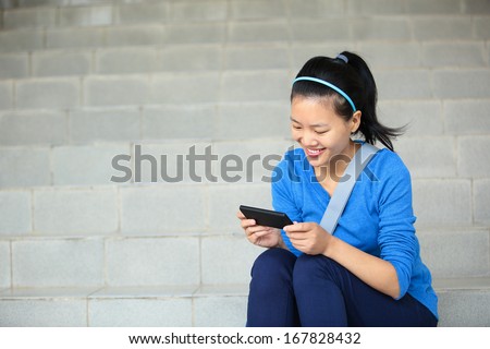 college student use smart phone sit on stairs