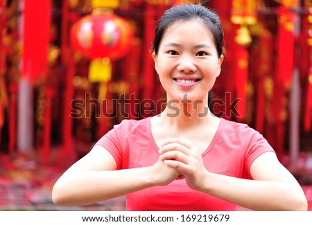 young asian woman wishing you a happy chinese new year