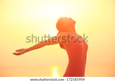 woman open arms under the sunrise at sea woman open arms under the sunrise at sea