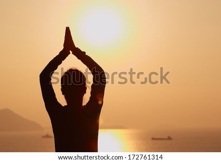 back of healthy  woman practice yoga at sunrise seaside