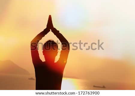 back of healthy  woman practice yoga at sunrise seaside