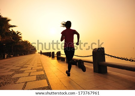 Runner athlete running at seaside. woman fitness silhouette sunrise jogging  workout wellness concept.