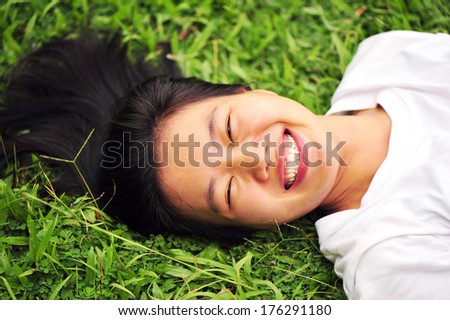 woman laying down in grass