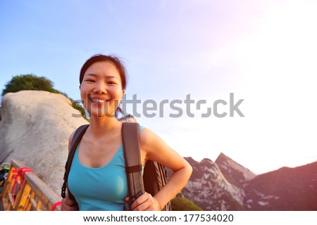 young woman hiker at peak of mount huashan