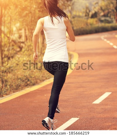 young fitness woman running cross country