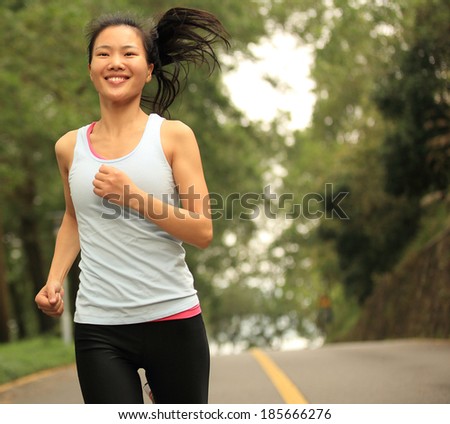 young fitness woman running cross country