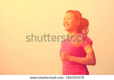 healthy lifestyle asian woman jogging at sunrise seaside
