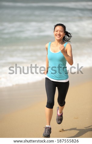 runner athlete feet running on beach. woman fitness jogging workout wellness concept
