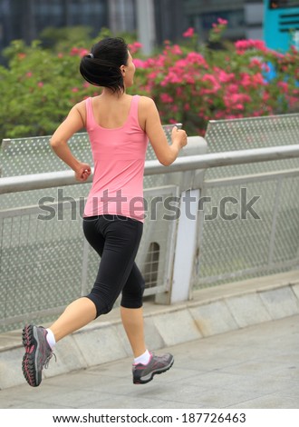 Runner athlete running at city. woman fitness jogging workout wellness concept.