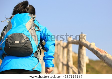 hiking woman climbing mountain stairs