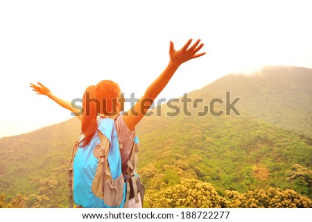 cheering hiking woman enjoy the beautiful view at mountain peak cheering hiking woman enjoy the beautiful view at mountain peak