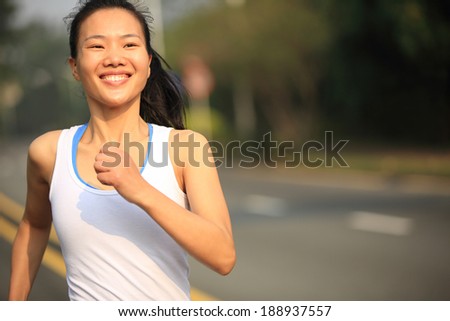 Runner athlete running at road. woman fitness  jogging  workout wellness concept.