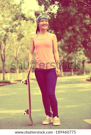 fitness young woman skateboard in hands