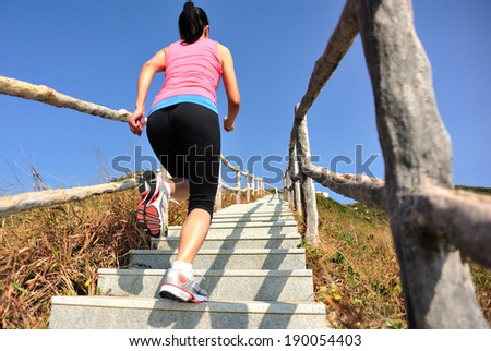 sports woman running/move up on mountain stairs