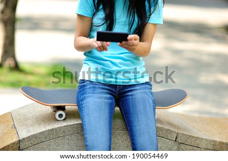 woman skateboarder sit on stairs use her cellphone